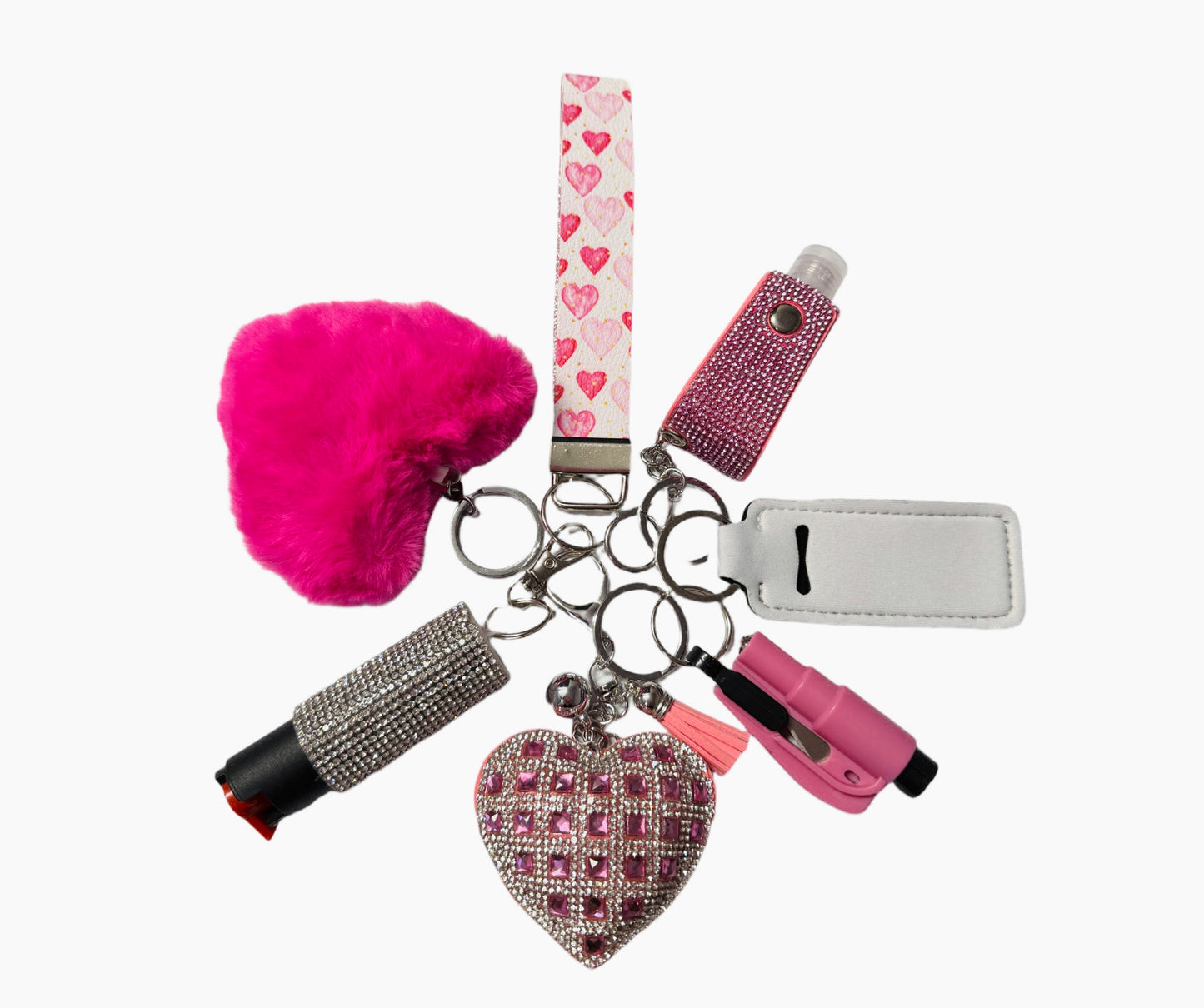 Includes: Pink Heart Wristlet, Bling Heart Charm, Seat Belt Cutter, Chapstick Holder, Bling Hand Sanitizer, Pepper Spray and Pompom.